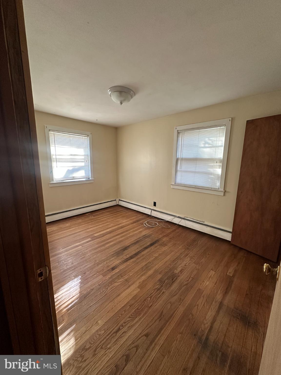 809 Somerdale Road Voorhees, NJ 08043 - Photo 14 of 20 an empty room with wooden floor and windows