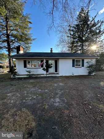 a view of house with backyard and trees