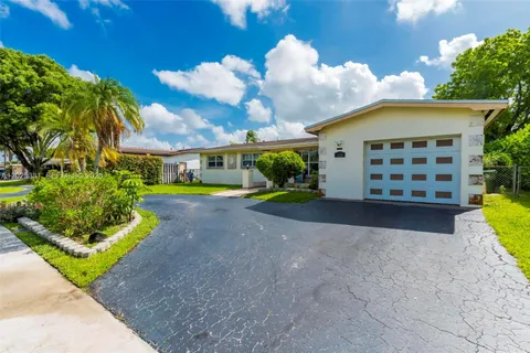 a view of a house with a yard and garden