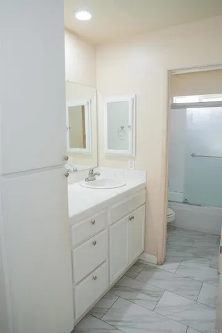 a bathroom with a double vanity sink and a mirror