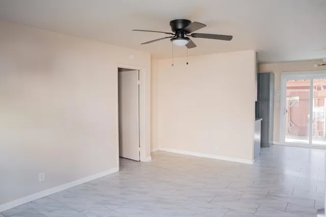 a view of a livingroom with a hardwood floor and a ceiling fan