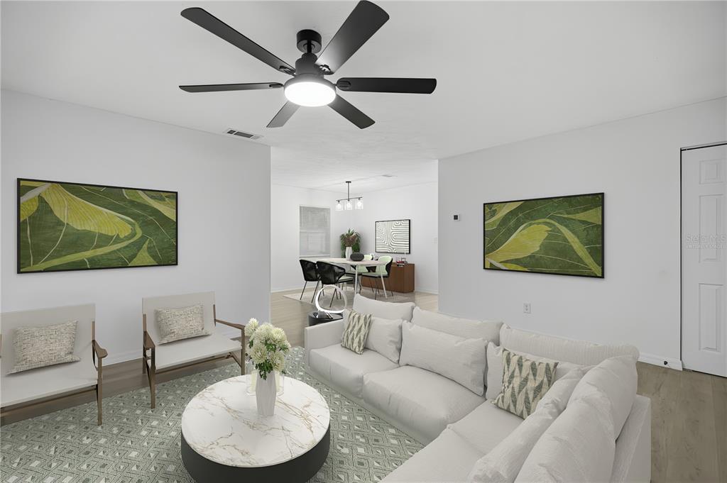 3753 Southeast 67th Place Ocala, FL 34480 - Photo 1 of 30 a living room with furniture and a flat screen tv