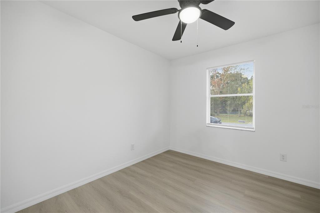 3753 Southeast 67th Place Ocala, FL 34480 - Photo 19 of 30 an empty room with a window and a fan