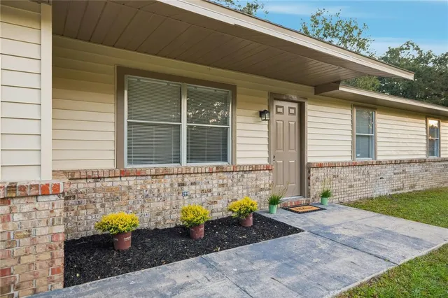 a front view of a house with outdoor seating