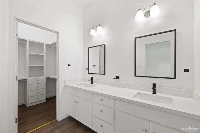 a bathroom with double vanity sink and a mirror