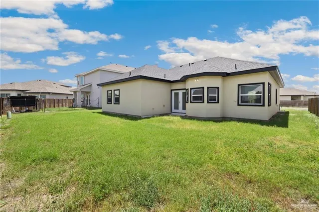 a view of a house with a backyard