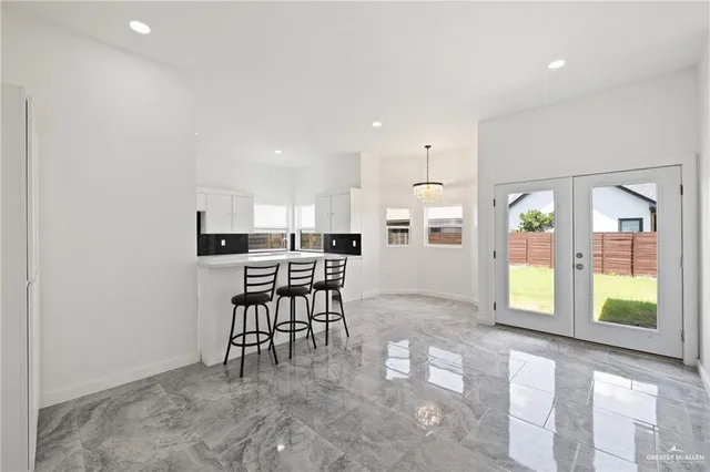 a view of a kitchen with kitchen island dining table and chairs