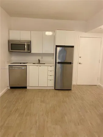 a kitchen with stainless steel appliances a refrigerator stove microwave and sink