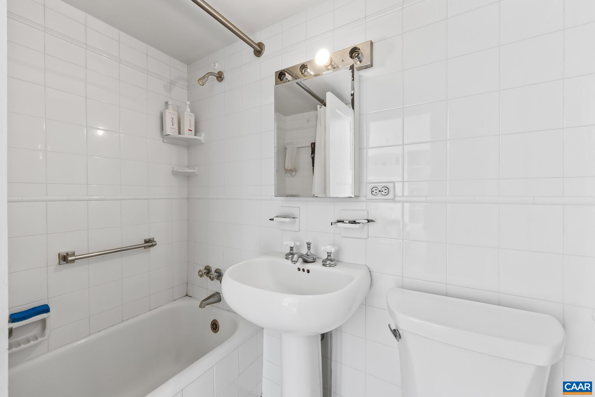500 Court Square, Unit 505 Charlottesville, VA 22902 - Photo 15 of 16 a bathroom with a sink a toilet and shower