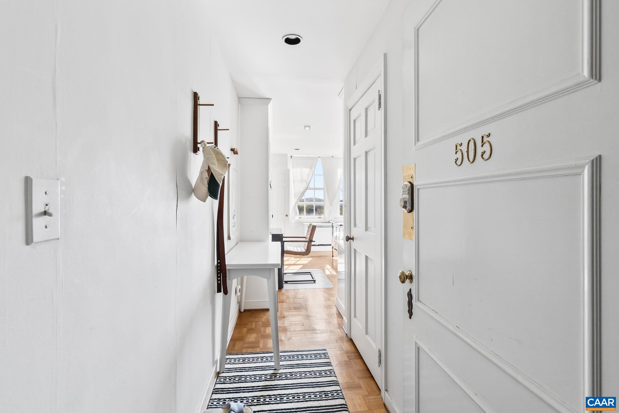 500 Court Square, Unit 505 Charlottesville, VA 22902 - Photo 7 of 16 a view of a hallway with a white walls and wooden floor