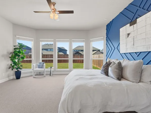 a bedroom with bed and flat screen tv