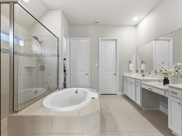 a bathroom with a bathtub and shower