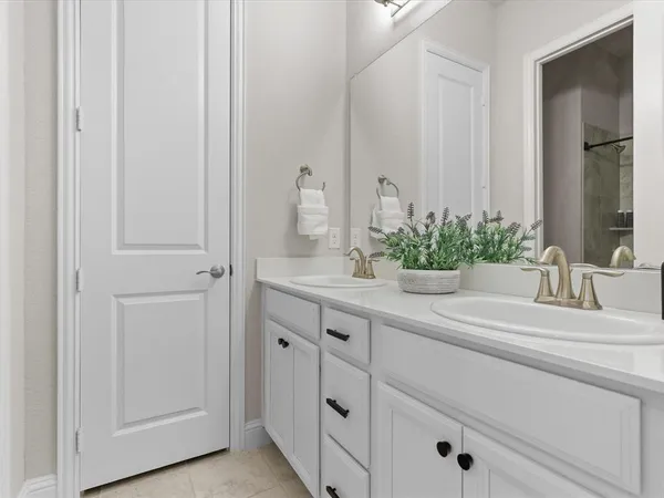 a white toilet sitting next to a white sink and vanity
