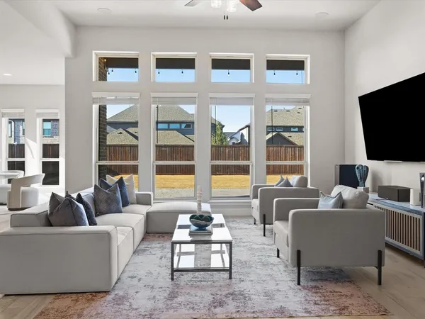 a living room with furniture a fireplace and a flat screen tv