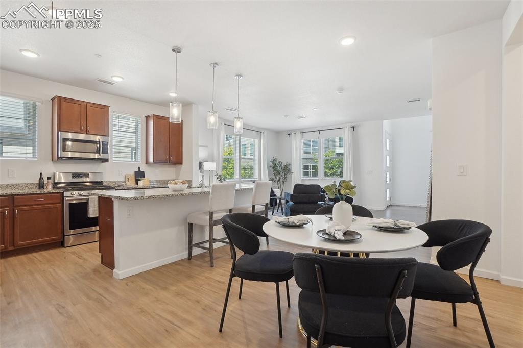 1743 Spring Water Point Colorado Springs, CO 80908 - Photo 11 of 35 a view of a dining room with furniture and wooden floor