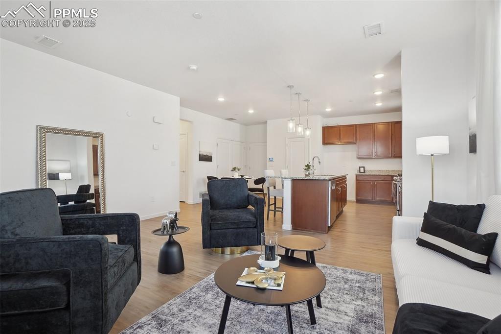 1743 Spring Water Point Colorado Springs, CO 80908 - Photo 15 of 35 a living room with furniture kitchen view and a table