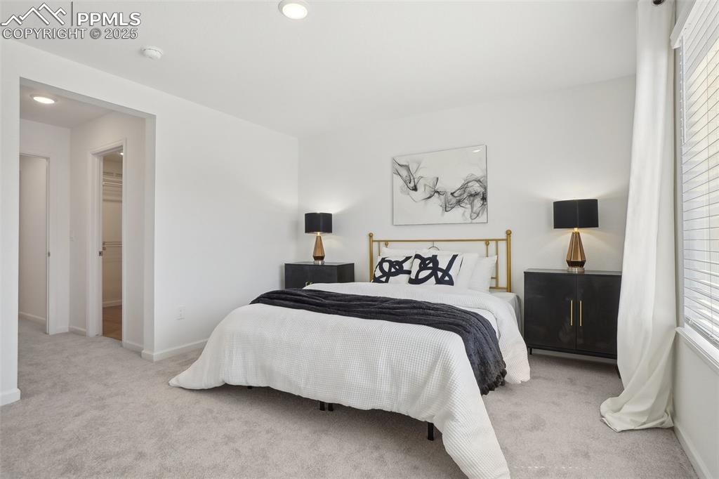 1743 Spring Water Point Colorado Springs, CO 80908 - Photo 18 of 35 a bedroom with a bed and a painting on the wall