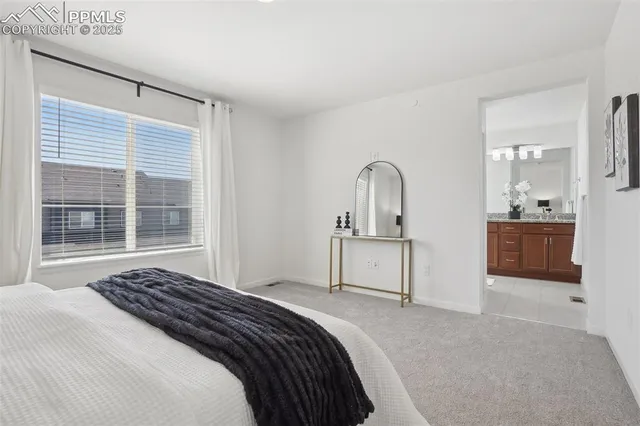 a bedroom with bed and a large window