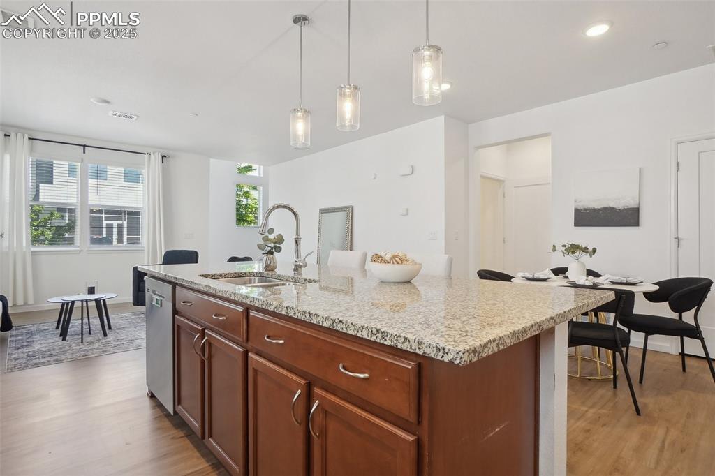 1743 Spring Water Point Colorado Springs, CO 80908 - Photo 7 of 35 a kitchen with center island table and chairs