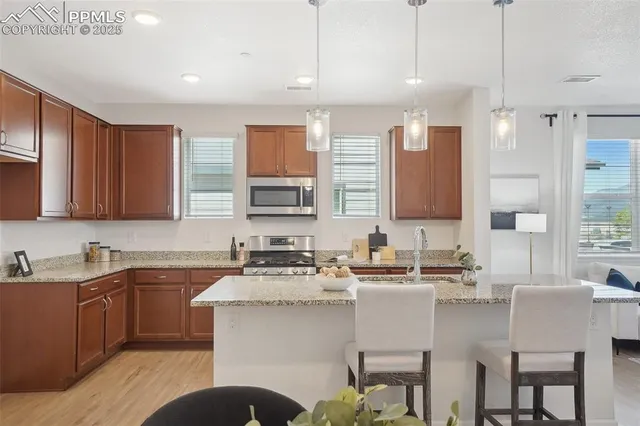 a kitchen with a sink stove and cabinets