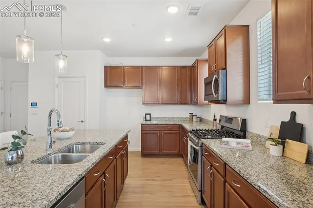 a kitchen with a sink stove and cabinets