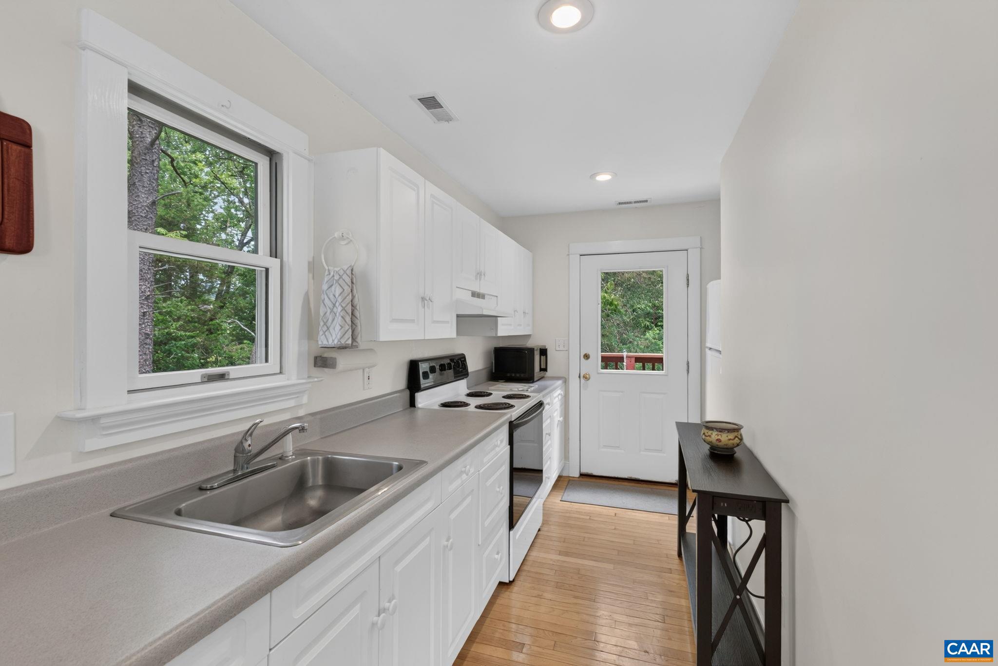 6285 Jarmans Gap Road Crozet, VA 22932 - Photo 33 of 65 a kitchen that has a sink a stove and window