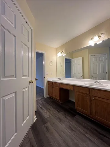 a spacious bathroom with a double vanity sink and a mirror