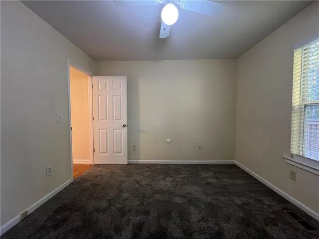 a bathroom with a toilet and a bath tub