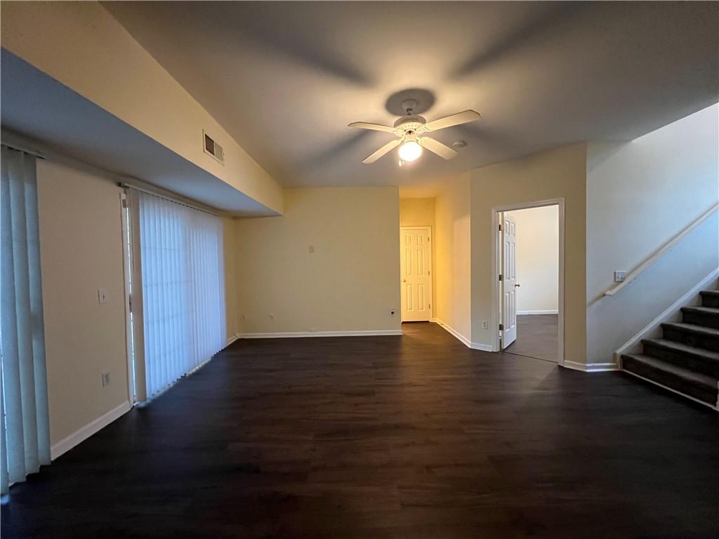 2705 Waymar Drive Southwest Marietta, GA 30008 - Photo 26 of 28 a view of an empty room with wooden floor and a ceiling fan