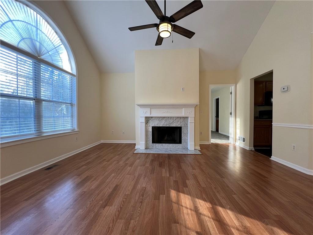 2705 Waymar Drive Southwest Marietta, GA 30008 - Photo 3 of 28 a view of a livingroom with wooden floor a ceiling fan and windows