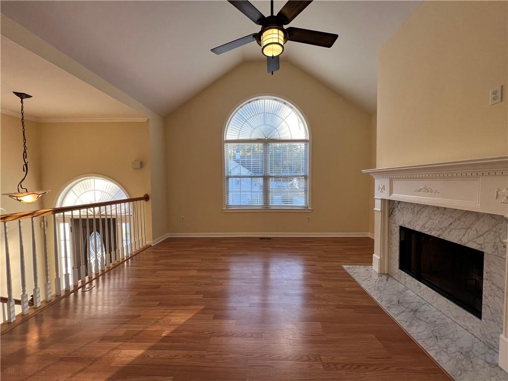 2705 Waymar Drive Southwest Marietta, GA 30008 - Photo 4 of 28 an empty room with wooden floor fireplace and windows