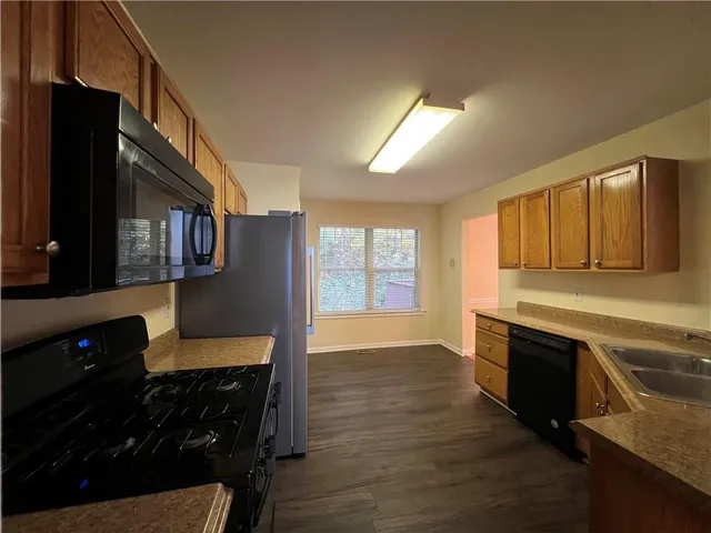 a kitchen with granite countertop a stove and cabinets