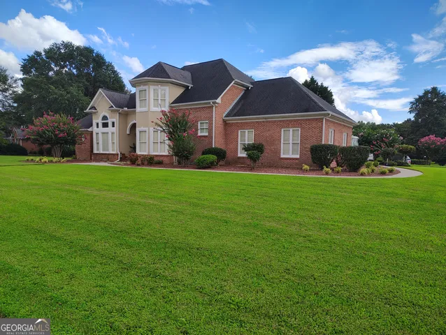 a front view of a house with a yard