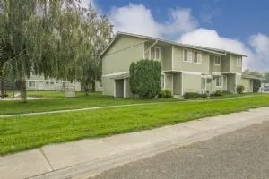 a front view of house with yard and green space