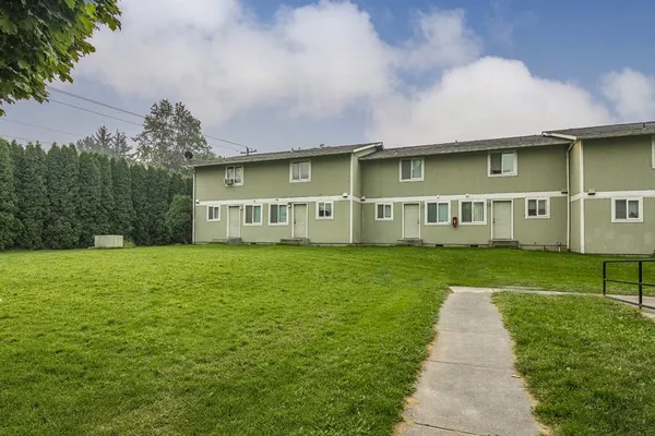 a front view of house with yard and green space