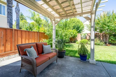 a view of a backyard with couches and plants