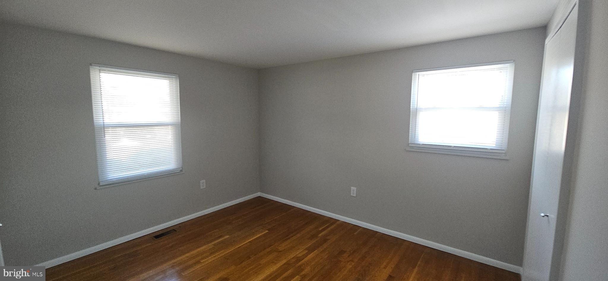 232 Myrtle Avenue Winchester, VA 22601 - Photo 12 of 36 an empty room with wooden floor and windows