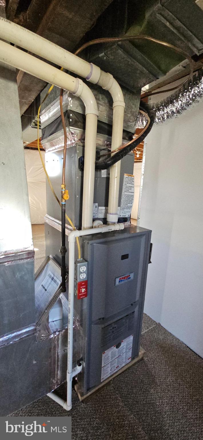 232 Myrtle Avenue Winchester, VA 22601 - Photo 23 of 36 a room with water heater and a cabinet