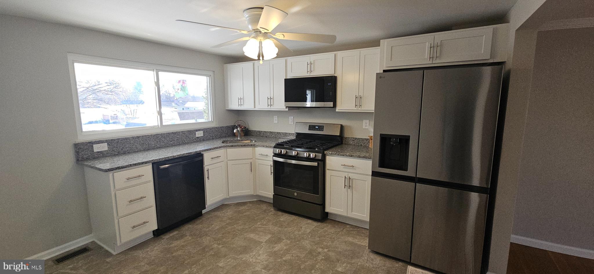 232 Myrtle Avenue Winchester, VA 22601 - Photo 7 of 36 a kitchen with stainless steel appliances a refrigerator sink and microwave