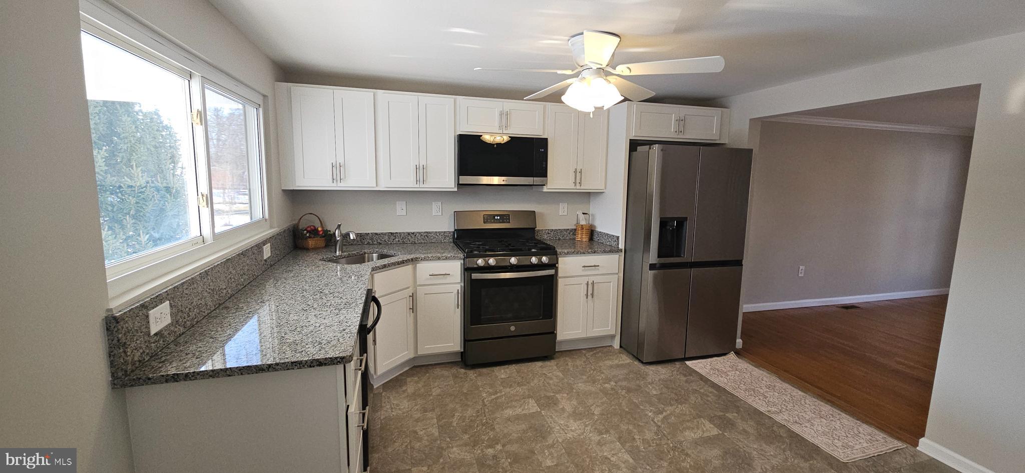 232 Myrtle Avenue Winchester, VA 22601 - Photo 8 of 36 a kitchen with stainless steel appliances granite countertop a refrigerator a stove a sink and a microwave