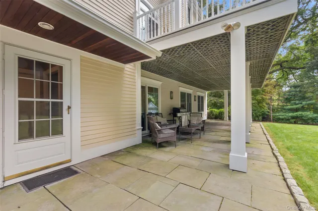 a view of house with backyard and outdoor seating