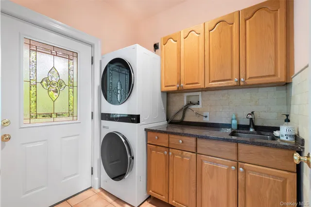 a kitchen with a sink a stove and a washing machine with window