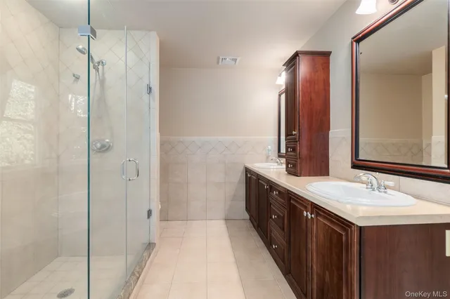 a bathroom with a double vanity sink and mirror
