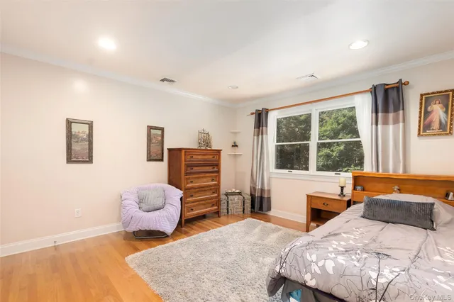 a bedroom with furniture and a large window