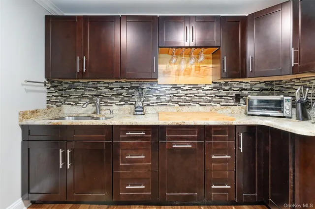 a kitchen with sink and cabinets