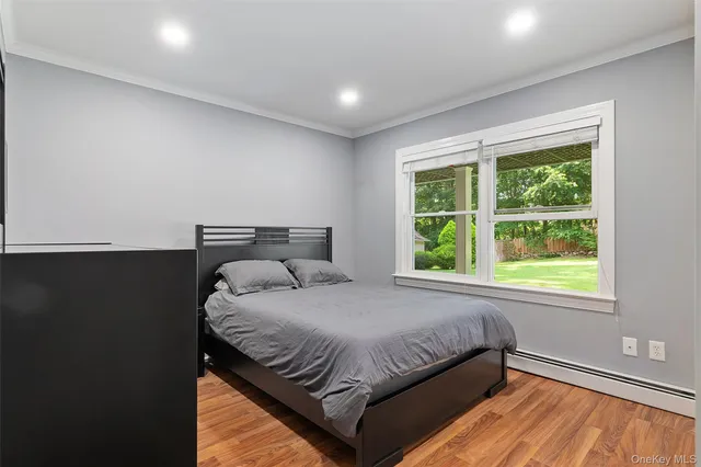 a bed sitting in a bedroom next to a window