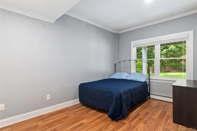 a living room with a bed and a window