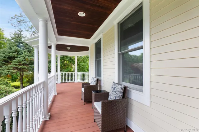a balcony with wooden floor and furniture