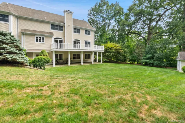 a view of a big yard with plants and large trees