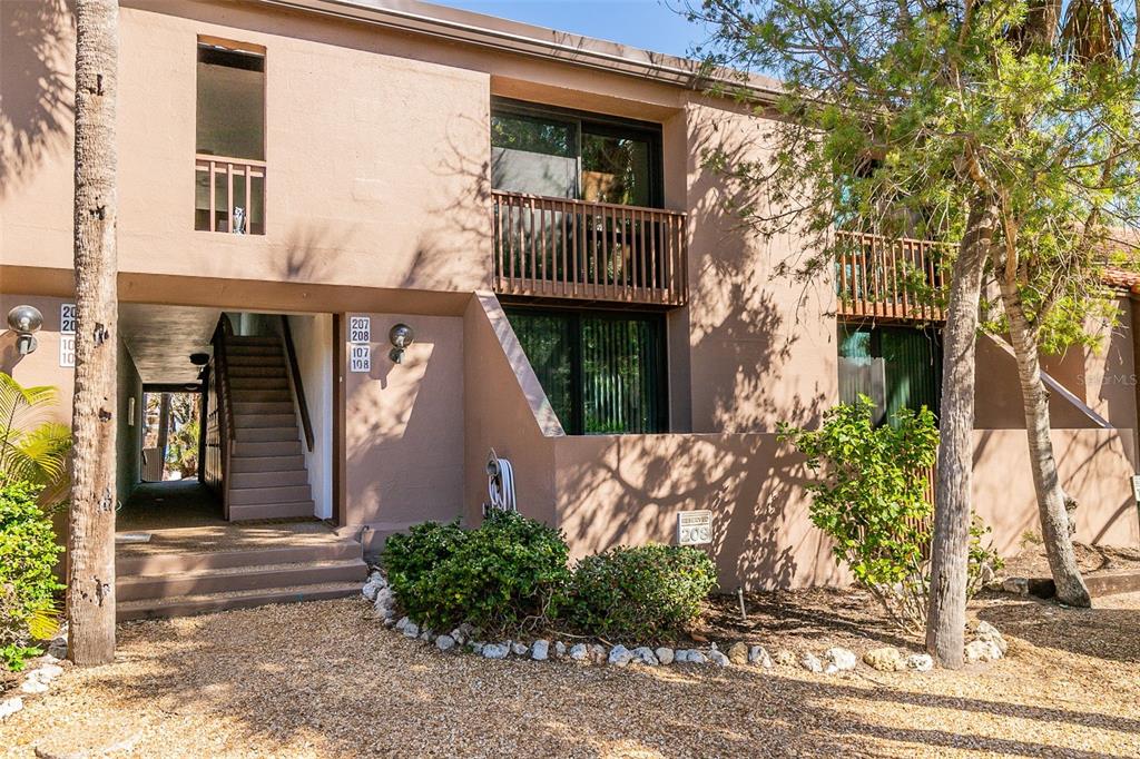 208 Pass Key Road, Unit 208 Sarasota, FL 34242 - Photo 1 of 29 a front view of a house with garden